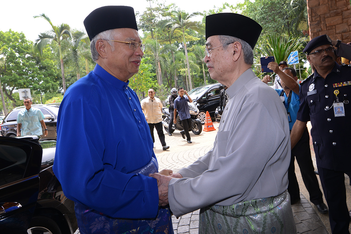 Prime Minister Datuk Seri Najib Razak (left) at former prime minister Tun Abdullah Ahmad Badawi’s Hari Raya open house in Putrajaya yesterday. Najib’s lawyers are now overseas on an exploratory mission in relation to their client's case against The Wall Street Journal, which published a report on July 2 that billions of ringgit were channelled into the prime minister’s bank accounts. – The Malaysian Insider pic by Nazir Sufari, July 27, 2015.