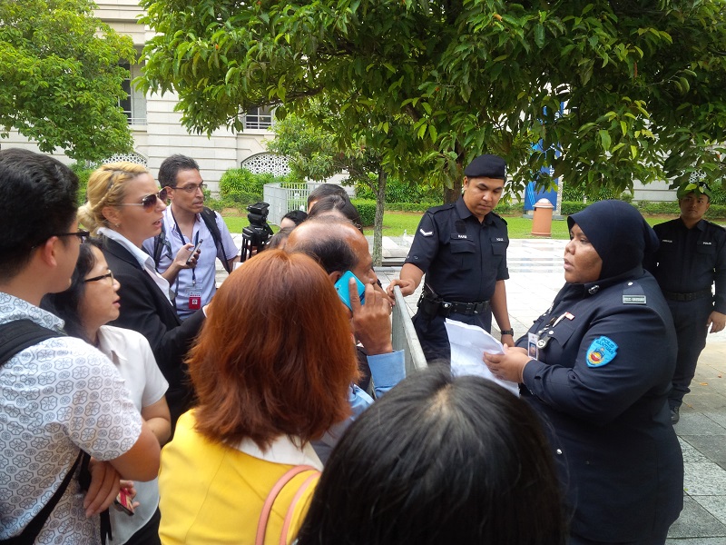 Reporters trying to negotiate with police personnel at the Palace of Justice in Putrajaya after being denied entry into the courthouse to cover Datuk Seri Anwar Ibrahim's sodomy appeal. – The Malaysian Insider pic, October 28, 2014.