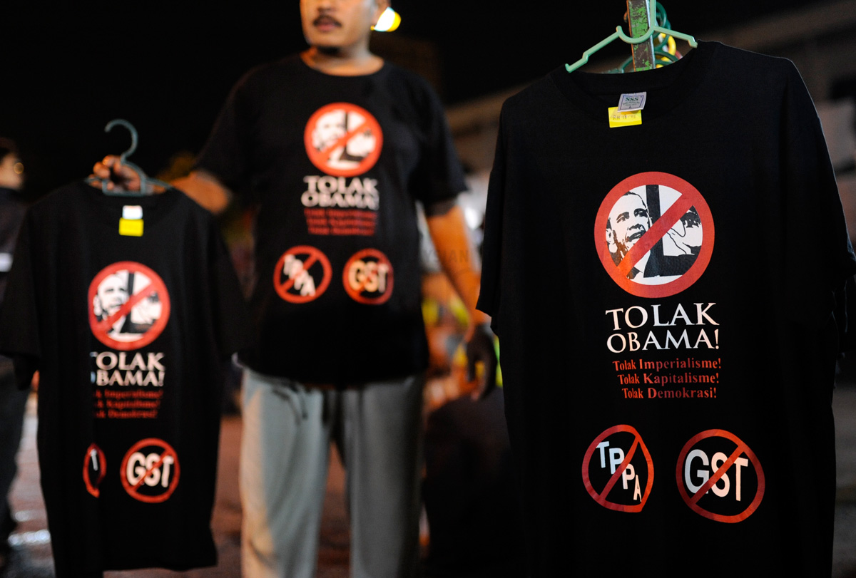 A street vendor selling T-shirts with logos of anti-goods and services tax (GST) and the Trans-Pacific Partnership Agreement (TPPA) with an image of US President Barack Obama at an anti-GST campaign called ‘Understand GST, Reject GST’ in Kuala Lumpur on Friday. – The Malaysian Insider pic by Najjua Zulkefli, December 22, 2013.  