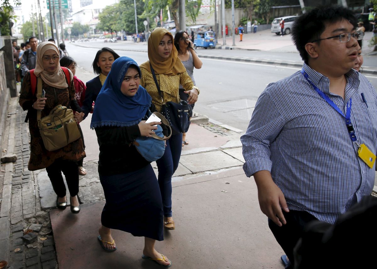 Office workers in the Thamrin business district in Jakarta are evacuated following several bomb blasts which hit the Indonesian capital today. – Reuters pic, January 14, 2016.