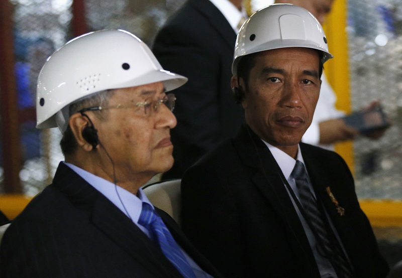 Tun Dr Mahathir Mohamad, seen here with visiting Indonesia president Joko Widodo at the Proton plant last year, is also the adviser of Petronas. – Reuters pic, March 6, 2016.