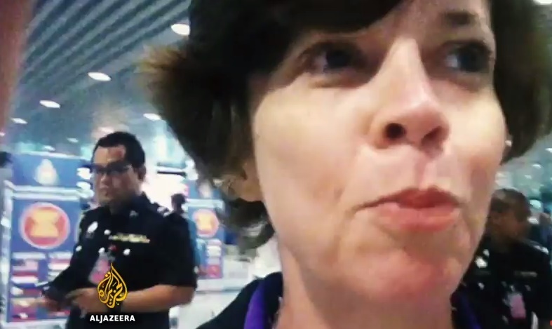 Journalist Mary Ann Jolley as she is led away by officers at the Kuala Lumpur International Airport, following her investigative piece on the Altantuya murder. The half-hour documentary was aired on Al Jazeera's 101 East programme today. – September 11, 2015.