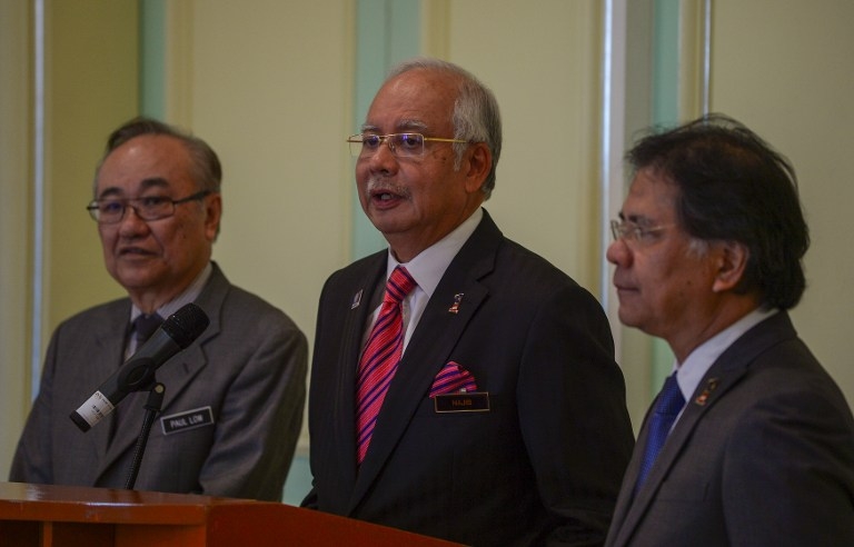 Datuk Paul Low with Datuk Seri Najib Razak and Pemandu chief Datuk Seri Idris Jala, during the announcement of a special committee to tackle political funding laws, yesterday. – AFP pic, August 15, 2015.