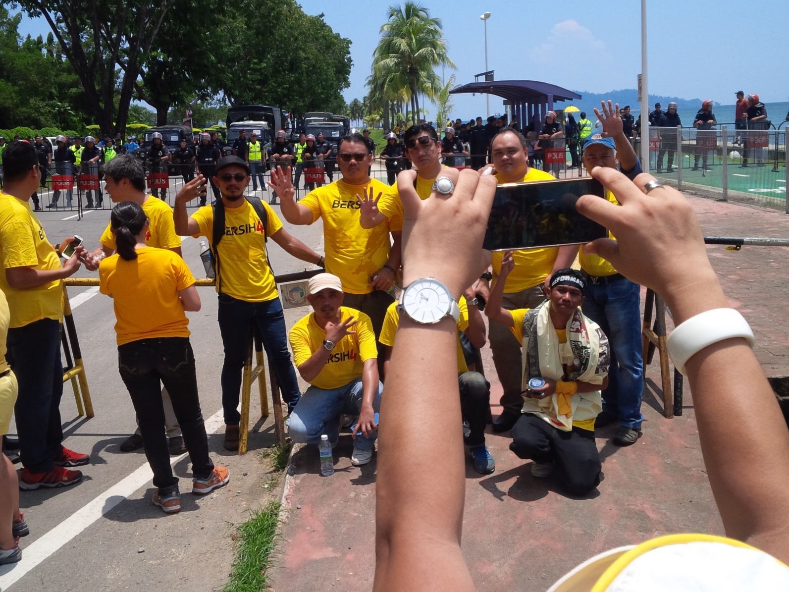 Some of the Bersih 4 participants in Kota Kinabalu, Sabah take pictures in front of the police barricade before dispersing. – The Malaysian Insider pic, August 30, 2015.