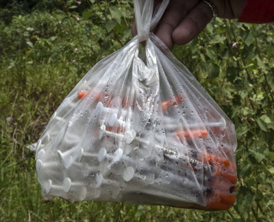 Plastic bag containing used needles to be handed to a health outreach worker for disposal. – Pic by Ahmad Yusni/Harm Reduction International, November 30, 2015.