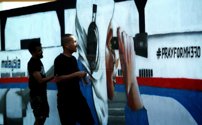 Members from Super Sunday working on a graffiti featuring missing Malaysia Airlines flight MH370 on a wall in Kuala Lumpur on March 24, 2014.  – The Malaysian Insider pic by Afif Abd Halim, April 8, 2014.