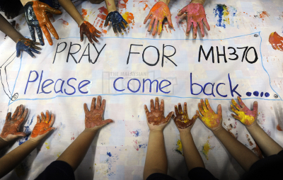 A note from well-wishers for the missing Malaysian Airline jetliner is written on a fabric at a school in Kajang, Selangor, on March 1, 2014. A Malaysia Airlines plane with 239 people on board went missing on March 8, 2014, en route from Kuala Lumpur to Beijing. – The Malaysian Insider pic by Nazir Sufari, April 8, 2014.